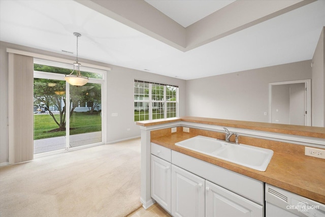 13611 Hemlock Rd, Huntley, IL 60142 - kitchen featuring white dishwasher, white cabinetry, light carpet, pendant lighting, and light countertops