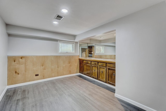9810 N Lauren Ln, Niles, IL 60714 - bar area featuring light wood-type flooring, wooden walls, wainscoting, and recessed lighting