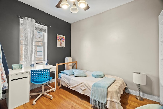 50 Forest Ave Unit 2S, Riverside, IL 60546 - bedroom featuring light wood-type flooring, a ceiling fan, and a chandelier