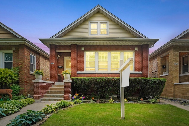4624 W Montana St, Chicago, IL 60639 - view of front facade featuring brick siding and a lawn