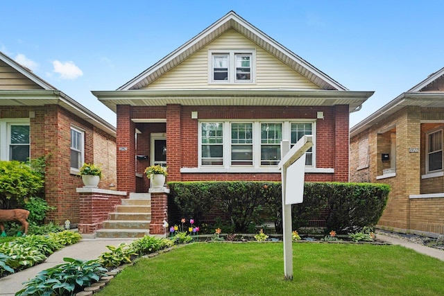 4624 W Montana St, Chicago, IL 60639 - view of front of home with brick siding, a front yard, and a porch