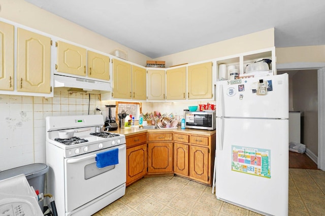 4624 W Montana St, Chicago, IL 60639 - kitchen with white appliances, under cabinet range hood, light countertops, and backsplash