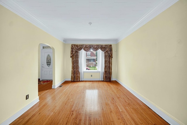 5736 S Honore St, Chicago, IL 60636 - unfurnished room featuring arched walkways, ornamental molding, and light wood-type flooring