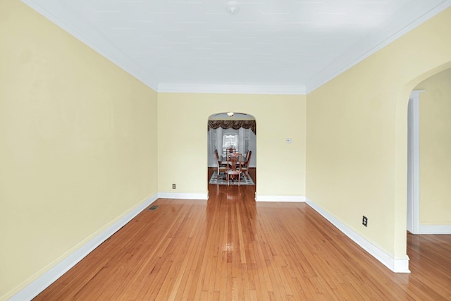 5736 S Honore St, Chicago, IL 60636 - spare room with arched walkways, light wood-type flooring, and ornamental molding