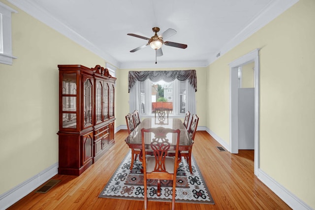 5736 S Honore St, Chicago, IL 60636 - dining space featuring light wood-type flooring, a ceiling fan, and crown molding