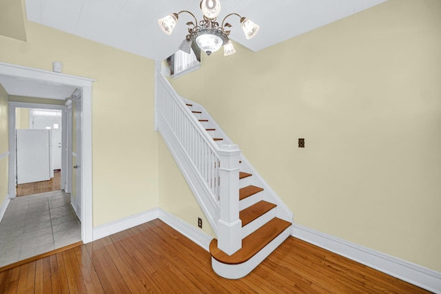 5736 S Honore St, Chicago, IL 60636 - stairway featuring a chandelier and wood-type flooring