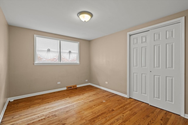 14427 Kenwood Ave, Dolton, IL 60419 - unfurnished bedroom featuring a closet and light wood-type flooring