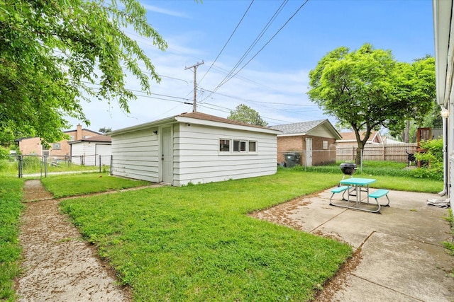 14427 Kenwood Ave, Dolton, IL 60419 - fenced backyard with a patio, an outbuilding, and a gate