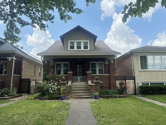 6735 Riverside Dr, Berwyn, IL 60402 - bungalow with covered porch, brick siding, roof with shingles, and a gate