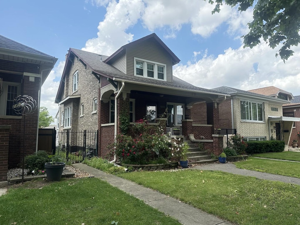 6735 Riverside Dr, Berwyn, IL 60402 - view of front of house featuring a porch, a front lawn, and brick siding