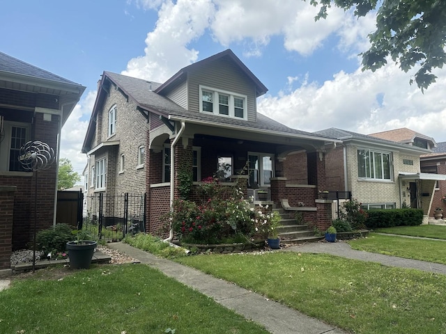 6735 Riverside Dr, Berwyn, IL 60402 - view of front of house featuring a porch, a front lawn, and brick siding