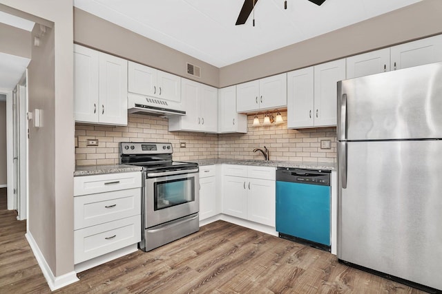 2237 175th St Unit 1B, Lansing, IL 60438 - kitchen featuring appliances with stainless steel finishes, under cabinet range hood, wood finished floors, and white cabinetry
