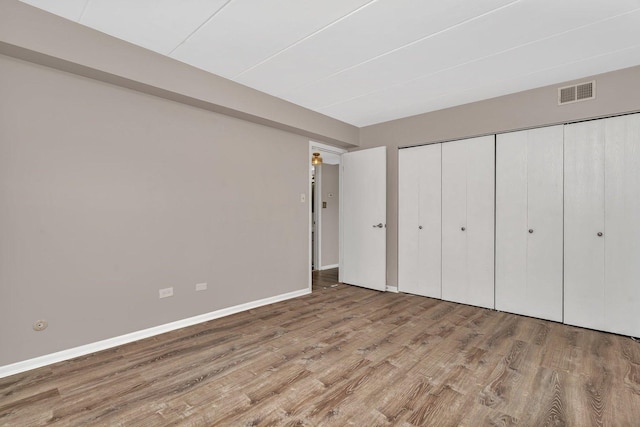 2237 175th St Unit 1B, Lansing, IL 60438 - unfurnished bedroom featuring wood finished floors and a closet