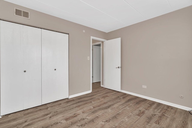 2237 175th St Unit 1B, Lansing, IL 60438 - unfurnished bedroom with wood finished floors and a closet