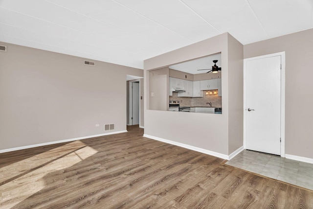 2237 175th St Unit 1B, Lansing, IL 60438 - unfurnished living room featuring wood finished floors and a ceiling fan