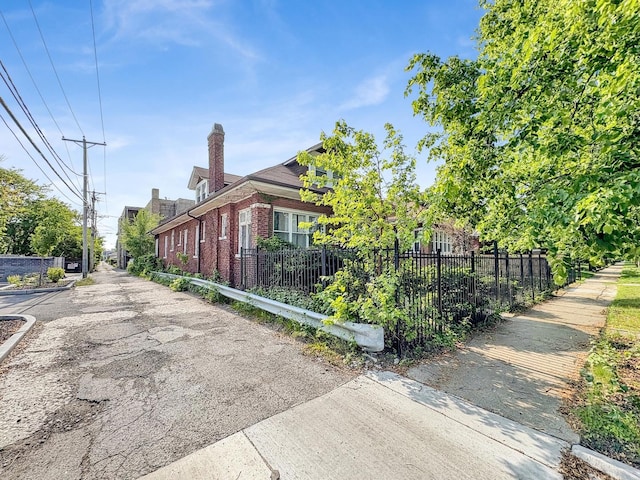 7515 S E End Ave, Chicago, IL 60649 - view of property exterior with brick siding and a fenced front yard