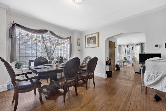 7515 S E End Ave, Chicago, IL 60649 - dining area featuring arched walkways, hardwood / wood-style flooring, and ornamental molding