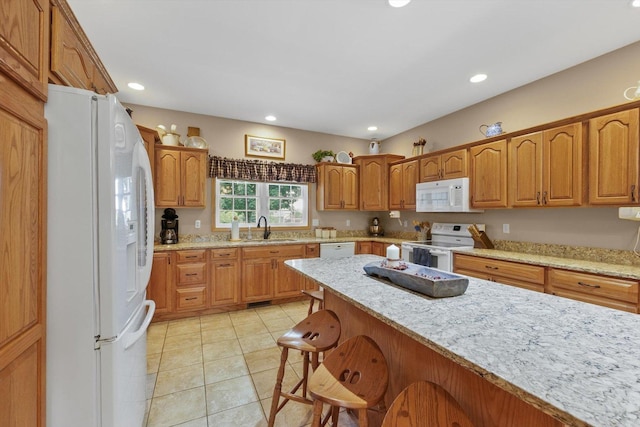 2598B County Road 600 E, Dewey, IL 61840 - kitchen with white appliances, a kitchen breakfast bar, light stone counters, recessed lighting, and light tile patterned flooring