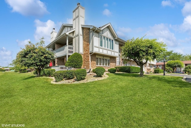 6713 181st St, Tinley Park, IL 60477 - rear view of property featuring a chimney, a lawn, and brick siding