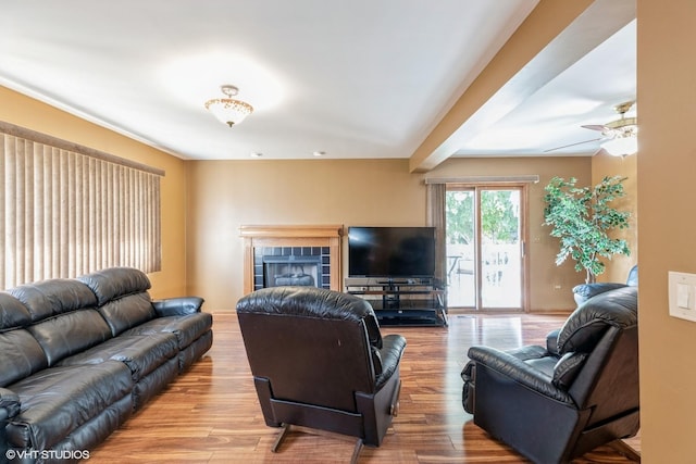 6713 181st St, Tinley Park, IL 60477 - living area featuring a tiled fireplace, wood finished floors, and ceiling fan
