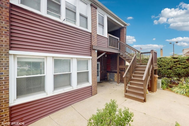 7318 W Archer Ave, Summit, IL 60501 - view of side of home featuring a patio area, stairs, and brick siding