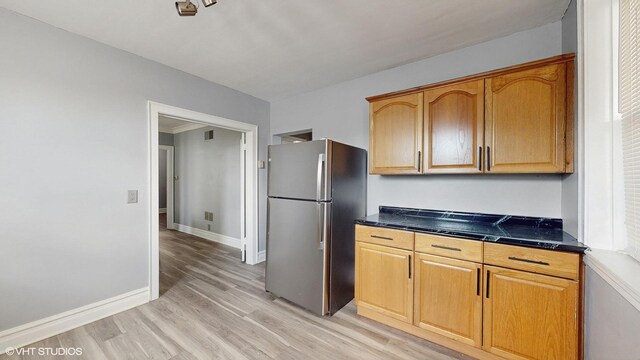 7318 W Archer Ave, Summit, IL 60501 - kitchen with freestanding refrigerator, dark countertops, and light wood-style flooring