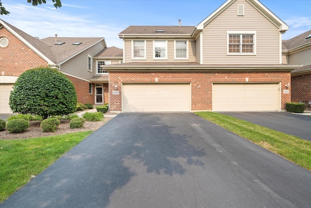 13261 Forest Ridge Dr Unit 0, Palos Heights, IL 60463 - view of front of home featuring asphalt driveway, brick siding, an attached garage, and roof with shingles