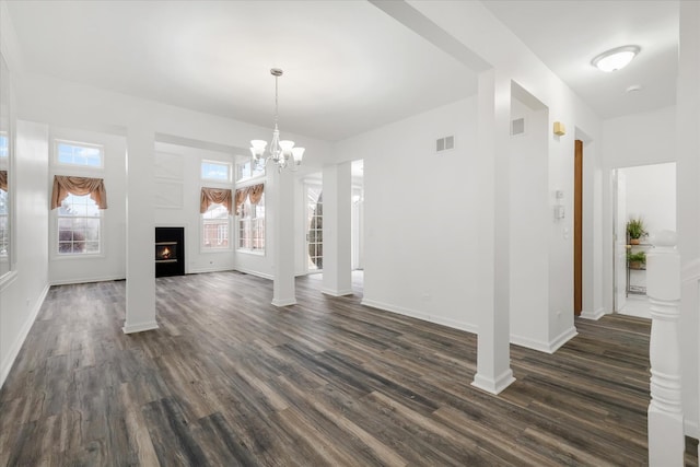 13261 Forest Ridge Dr Unit 0, Palos Heights, IL 60463 - unfurnished living room with dark wood-style flooring, a warm lit fireplace, and a chandelier