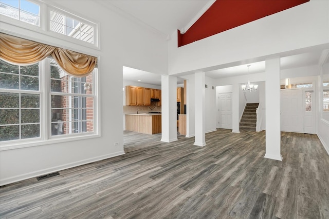13261 Forest Ridge Dr Unit 0, Palos Heights, IL 60463 - unfurnished living room featuring lofted ceiling, dark wood-type flooring, a chandelier, healthy amount of natural light, and crown molding