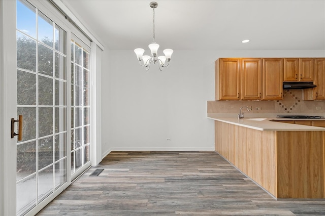 13261 Forest Ridge Dr Unit 0, Palos Heights, IL 60463 - kitchen with a chandelier, backsplash, light countertops, stovetop, and decorative light fixtures
