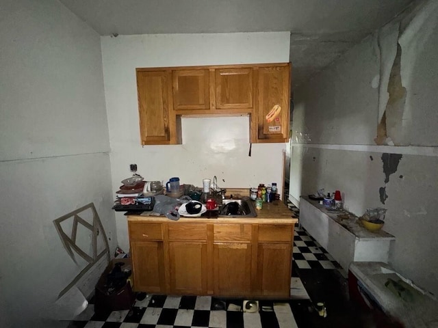 4038 W Adams St, Chicago, IL 60624 - kitchen with tile patterned floors, light countertops, and brown cabinetry