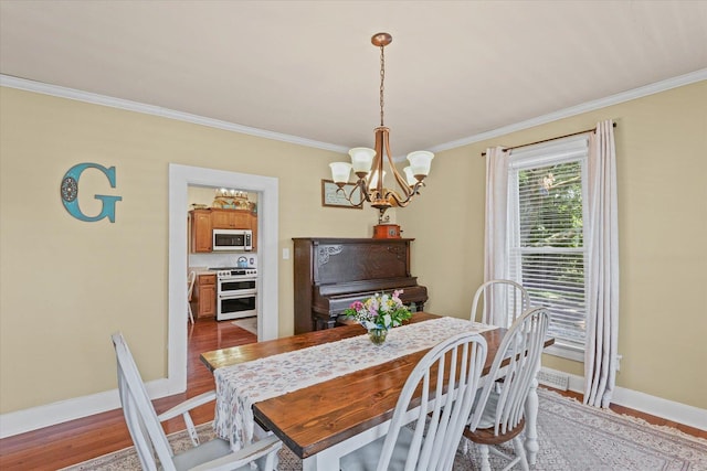 835 E Pells St, Paxton, IL 60957 - dining area featuring a chandelier, crown molding, and wood finished floors