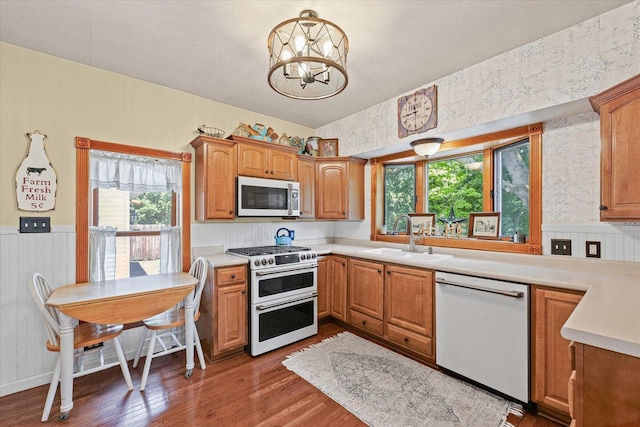 835 E Pells St, Paxton, IL 60957 - kitchen with white dishwasher, double oven range, wood finished floors, a chandelier, and light countertops