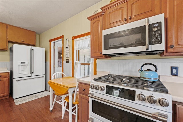 835 E Pells St, Paxton, IL 60957 - kitchen featuring white appliances, dark wood-style floors, light countertops, and brown cabinetry