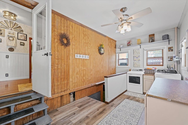 835 E Pells St, Paxton, IL 60957 - kitchen with washing machine and clothes dryer, light wood-style floors, ceiling fan, ornamental molding, and wood walls