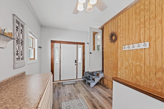 835 E Pells St, Paxton, IL 60957 - foyer with crown molding, light wood-type flooring, a ceiling fan, and wooden walls