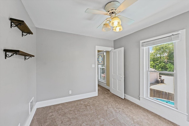 835 E Pells St, Paxton, IL 60957 - carpeted spare room featuring baseboards and a ceiling fan