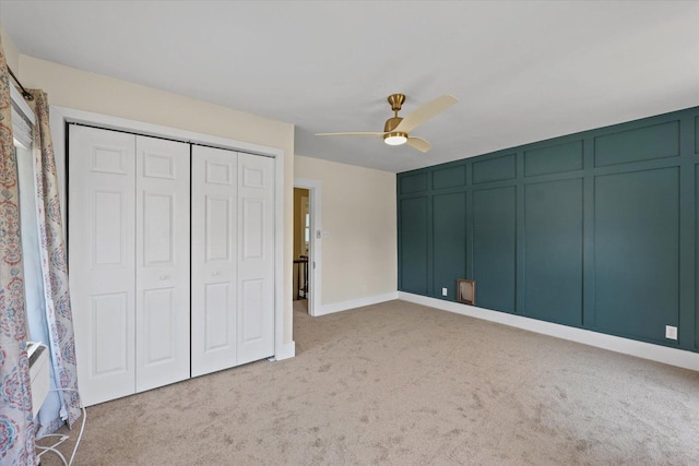 835 E Pells St, Paxton, IL 60957 - unfurnished bedroom with light carpet, a decorative wall, a closet, and a ceiling fan