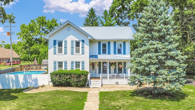 835 E Pells St, Paxton, IL 60957 - view of front of property featuring covered porch, a metal roof, an outdoor pool, and a standing seam roof