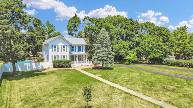835 E Pells St, Paxton, IL 60957 - colonial-style house with a porch and a metal roof