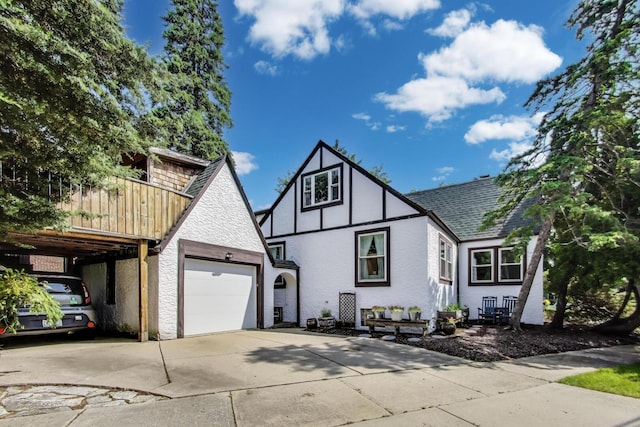 653 Blackstone Pl, Highland Park, IL 60035 - view of front facade with concrete driveway, stucco siding, a garage, and a shingled roof