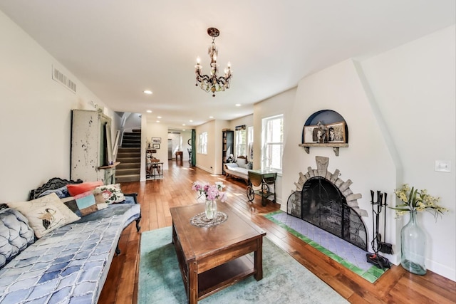 653 Blackstone Pl, Highland Park, IL 60035 - living area featuring stairway, hardwood / wood-style flooring, a large fireplace, recessed lighting, and a chandelier