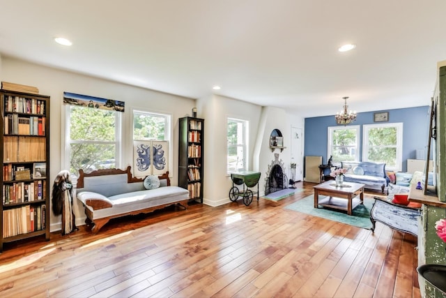 653 Blackstone Pl, Highland Park, IL 60035 - living room with healthy amount of natural light, a chandelier, hardwood / wood-style flooring, and recessed lighting