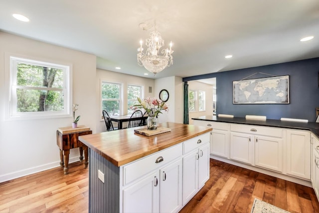 653 Blackstone Pl, Highland Park, IL 60035 - kitchen featuring butcher block countertops, a chandelier, hardwood / wood-style flooring, recessed lighting, and a kitchen island