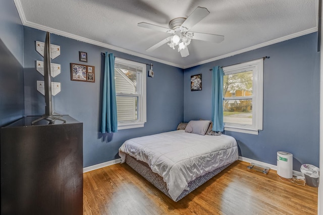 9116 S 53rd Ct, Oak Lawn, IL 60453 - bedroom featuring wood finished floors, ornamental molding, a textured ceiling, and ceiling fan
