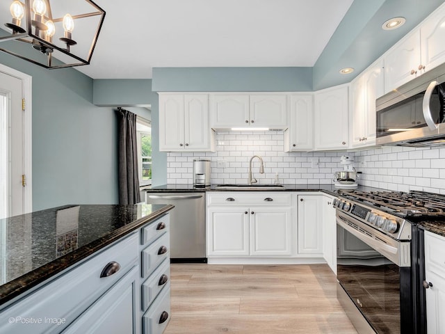 624 63rd St, Downers Grove, IL 60516 - kitchen featuring stainless steel appliances, a chandelier, dark stone countertops, recessed lighting, and backsplash