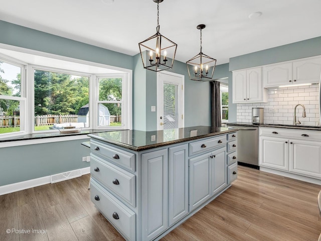 624 63rd St, Downers Grove, IL 60516 - kitchen with dishwasher, white cabinets, a chandelier, light wood-type flooring, and backsplash