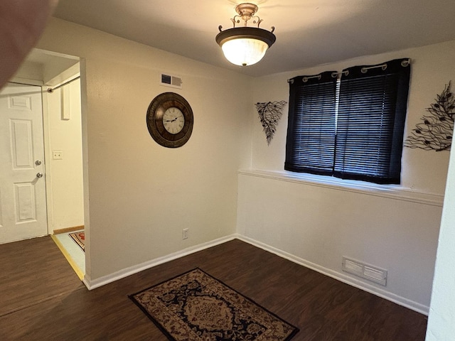 2841 10th St, Rockford, IL 61108 - spare room with baseboards and dark wood-style floors