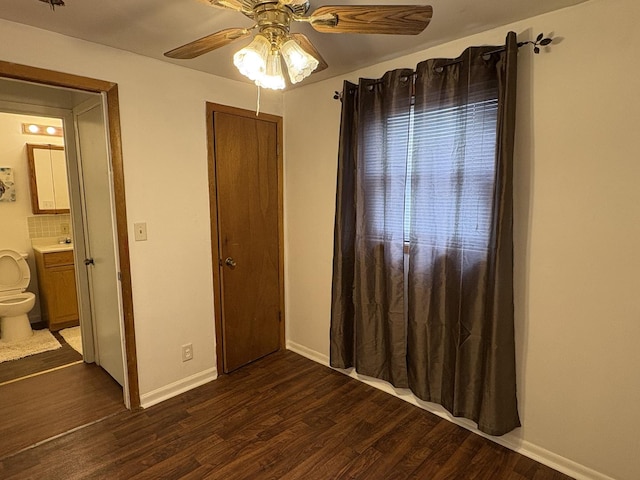 2841 10th St, Rockford, IL 61108 - unfurnished bedroom with dark wood-style floors, ensuite bath, and a ceiling fan