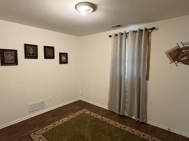 2841 10th St, Rockford, IL 61108 - spare room featuring dark wood-style floors and baseboards